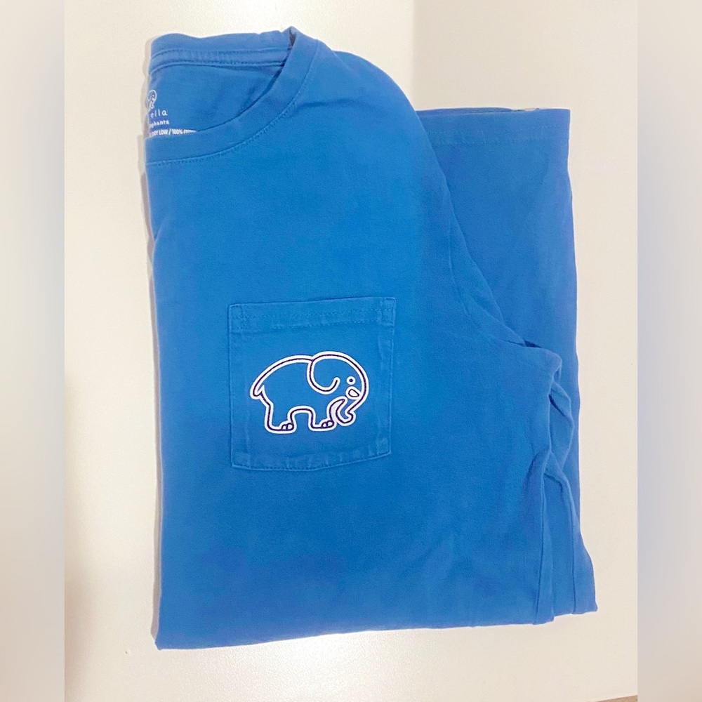 Ivory ella blue shirt. logo on front pocket, big colorful logo on the back